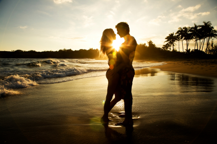Idyllic picture of a newly married couple enjoying their honeymoon on a tropical beach Idyllic picture of a newly married couple enjoying their honeymoon on a tropical beach